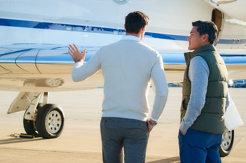 men standing in front of a private plane